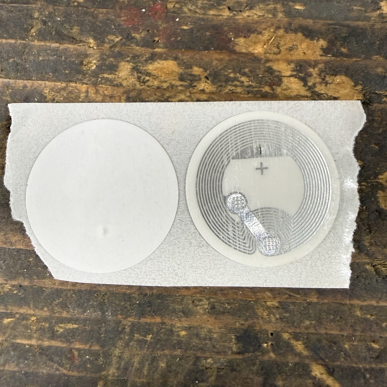 Front and back of a round NFC Type 2 sticker tag