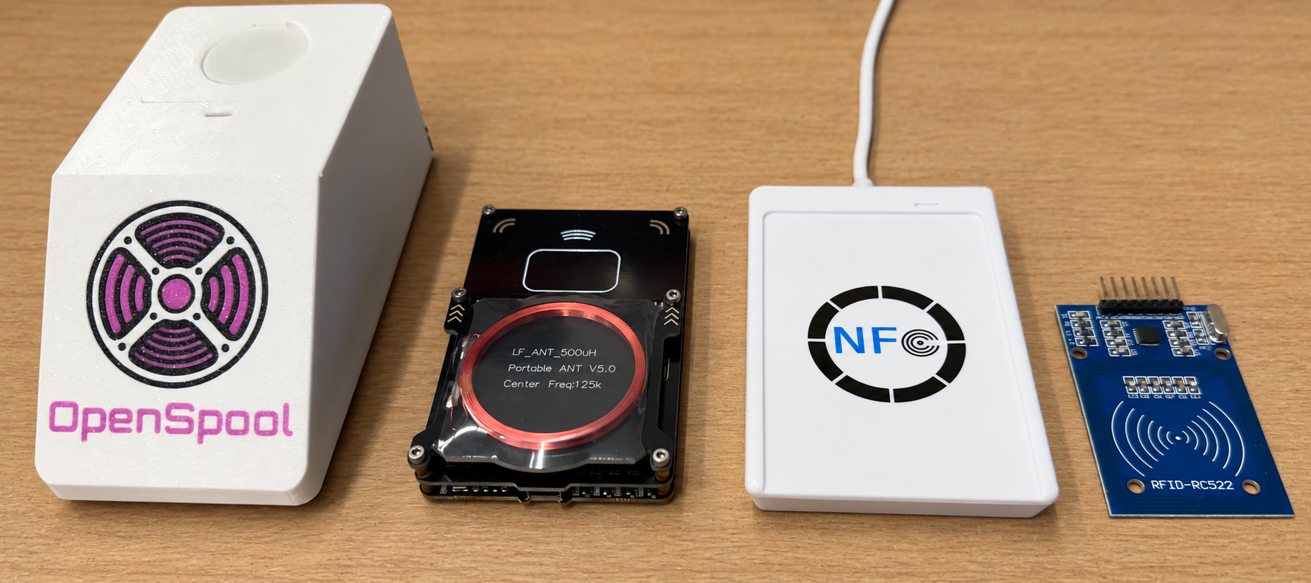 OpenSpool device, portable RFID reader, USB NFC reader, and RC522 module on a table